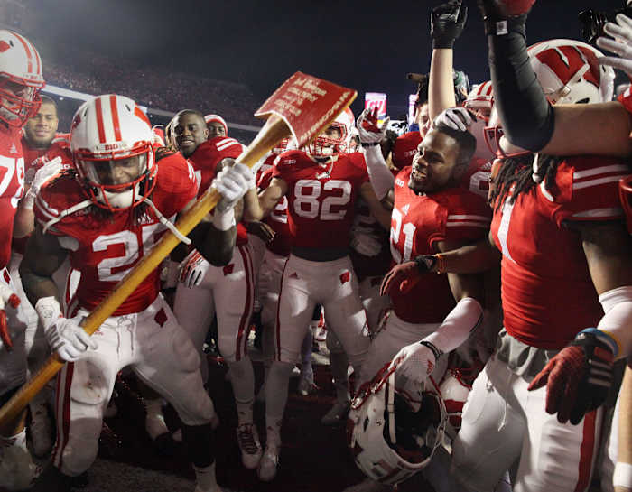 Melvin Gordon and teammates celebrate winning Paul Bunyan's Axe at Camp Randall Stadium.